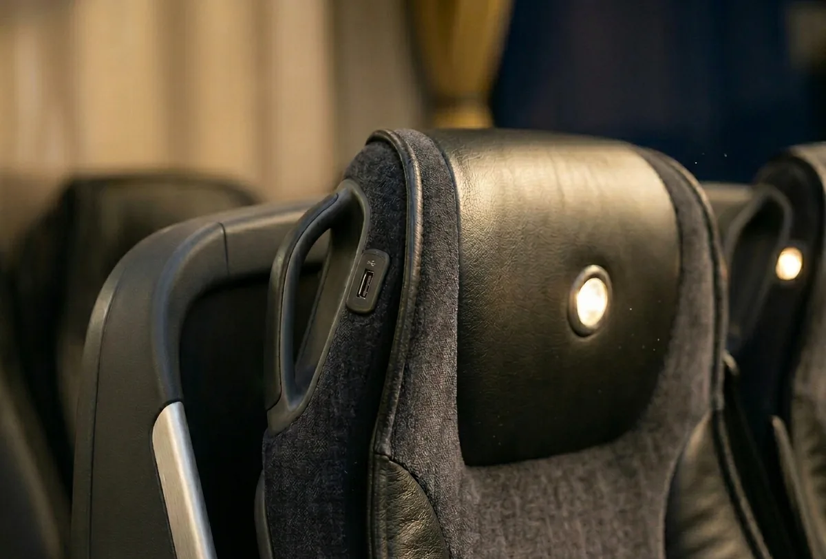 Motorcoach comfort detail — seats, USB ports and amenities